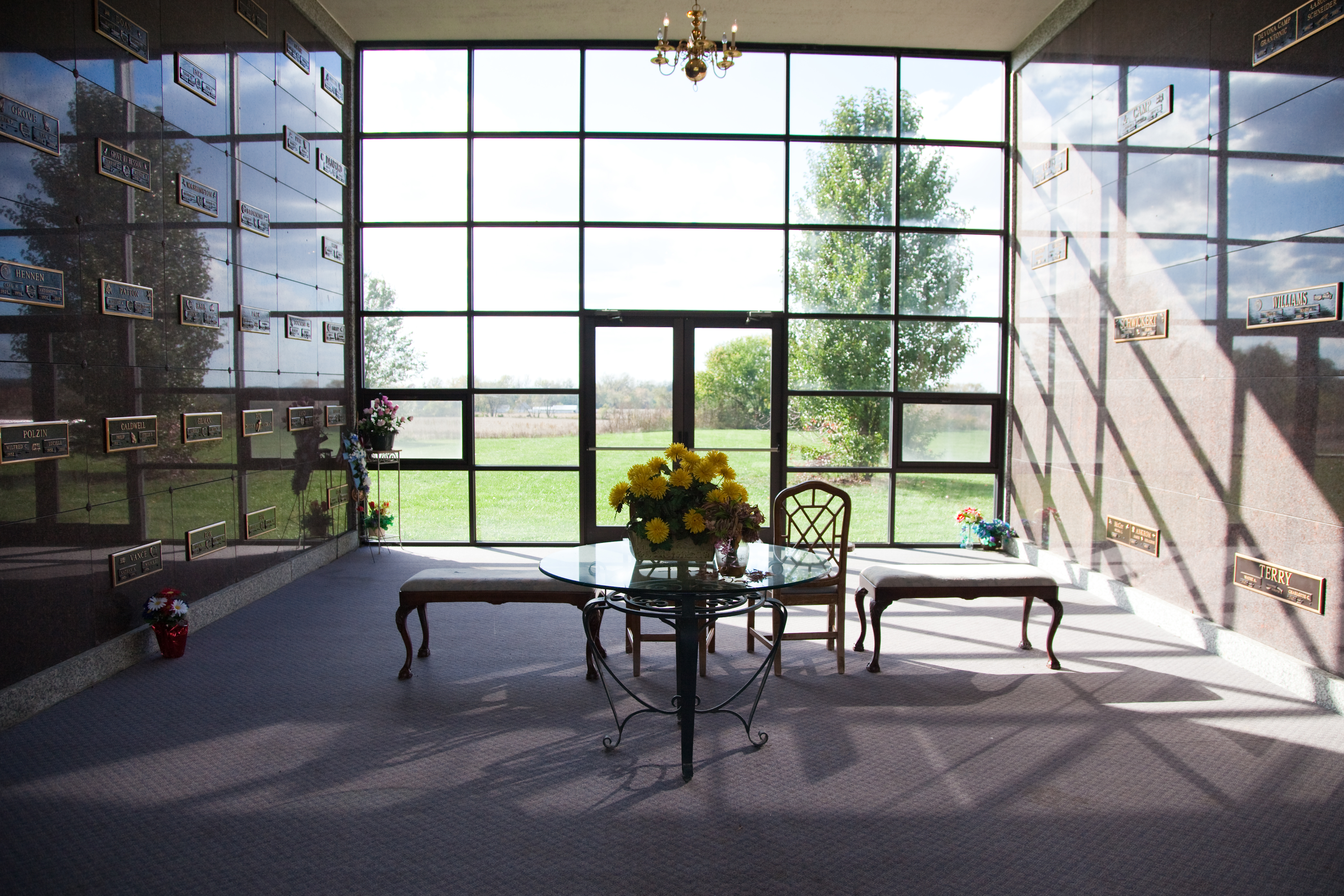 Walk-in chapel mausoleum with seating and stained glass windows